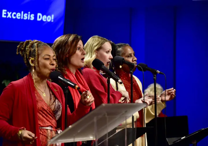 Bajan Moore singing with three other vocalists at a holiday service