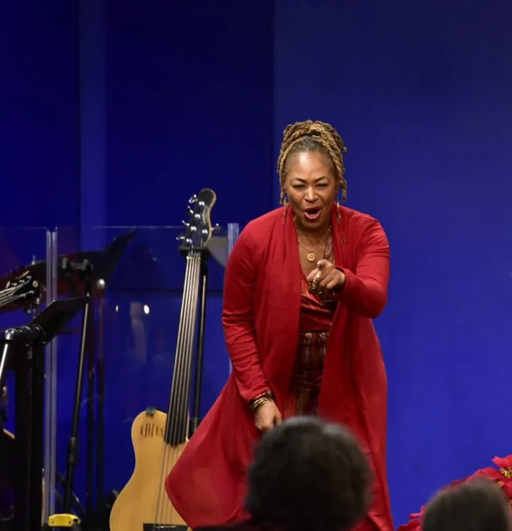 Bajan Moore singing out to the audience at a holiday service