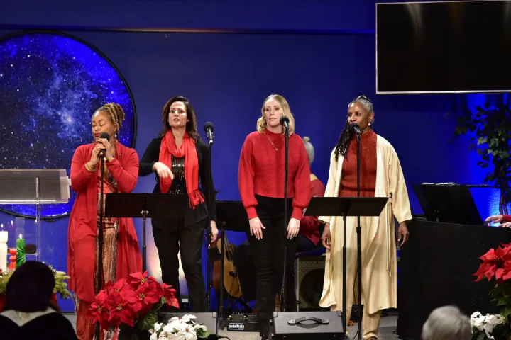 Bajan Moore and fellow vocalists on stage at a holiday service