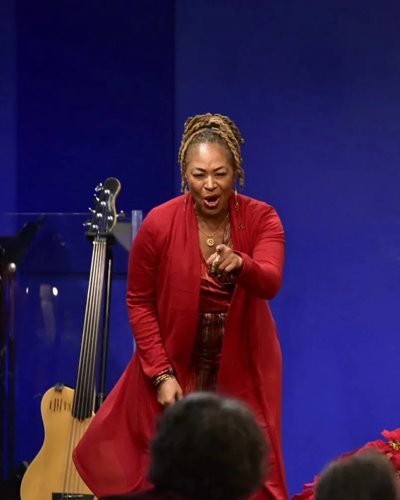 Bajan Moore singing out to the audience at a holiday service
